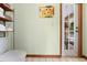 Neutral-toned bathroom includes a toilet, shelf with towels, and a door leading to a patio at 43350 Natchez St, Deland, FL 32720