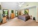 Spacious bedroom featuring a ceiling fan, carpeted floor, and two windows overlooking the outside at 43350 Natchez St, Deland, FL 32720
