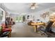 Spacious bonus room, featuring a large built-in desk, sofas, and natural light, offering versatile living and work space at 43350 Natchez St, Deland, FL 32720