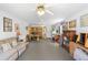 A large, carpeted bonus room provides flexible space with ceiling fans, ample windows and multiple furniture arrangement possibilities at 43350 Natchez St, Deland, FL 32720
