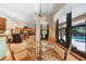 Inviting breakfast nook with a glass table, wicker chairs, and picturesque views of the sparkling pool at 43350 Natchez St, Deland, FL 32720