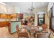 Charming breakfast nook with a glass table, wicker chairs, and an open view to the living and kitchen areas at 43350 Natchez St, Deland, FL 32720