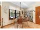 Cozy breakfast nook with a glass table, wicker chairs, and scenic views of the outdoor pool area at 43350 Natchez St, Deland, FL 32720