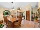 Spacious dining room with wood furnishings, unique window detail, and a welcoming atmosphere for Gathering gatherings at 43350 Natchez St, Deland, FL 32720
