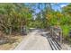 Gated entry into property, featuring a long driveway lined with lush landscaping, providing privacy and a sense of arrival at 43350 Natchez St, Deland, FL 32720