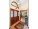 Inviting foyer with a classic wood door, ceramic tile flooring, and a view into the cozy living area at 43350 Natchez St, Deland, FL 32720