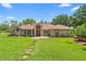 Charming single-story brick home with a well-manicured lawn and inviting entryway, blending classic style with outdoor appeal at 43350 Natchez St, Deland, FL 32720