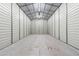 An indoor shot of an empty, bright garage with smooth concrete floors and white metal walls, lit by overhead fluorescent lights at 43350 Natchez St, Deland, FL 32720