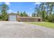 Spacious garage and workshop, offering ample storage and workspace for hobbies and projects, complemented by a wide driveway at 43350 Natchez St, Deland, FL 32720