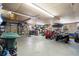 Interior of garage featuring equipment such as lawn mowers, four wheelers, storage shelves and tools at 43350 Natchez St, Deland, FL 32720