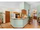 Open-concept kitchen with tiled flooring, wooden cabinetry, and easy access to living areas and front entrance at 43350 Natchez St, Deland, FL 32720