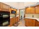 Spacious kitchen showcasing built-in appliances, wooden cabinetry, and convenient access to other areas of the home at 43350 Natchez St, Deland, FL 32720