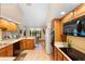 Bright kitchen featuring tile floors, wood cabinets, and updated appliances and an adjacent breakfast nook at 43350 Natchez St, Deland, FL 32720