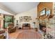 Inviting living room featuring a fireplace, tile flooring, and ample natural light, creating a cozy atmosphere at 43350 Natchez St, Deland, FL 32720