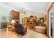 Comfortable living room features a brick fireplace, neutral tones, tile flooring, and abundant natural light at 43350 Natchez St, Deland, FL 32720
