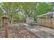 Beautiful backyard featuring a brick paver patio, mature trees, and a storage shed at 441 N Julia Ave, Deland, FL 32720