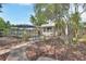 Spacious backyard featuring a brick paver patio, mature trees, and lush greenery at 441 N Julia Ave, Deland, FL 32720