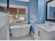 Modern bathroom featuring a soaking tub and a stylish vanity with marble countertop at 441 N Julia Ave, Deland, FL 32720