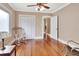 Bedroom featuring wood floors, closet with bi-fold doors and an open view to another room at 441 N Julia Ave, Deland, FL 32720