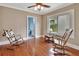 Serene bedroom featuring two rocking chairs, hardwood floors, and a bright window view at 441 N Julia Ave, Deland, FL 32720