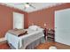Cozy bedroom featuring hardwood floors, floral wallpaper, and a comfortable bed with bedside table at 441 N Julia Ave, Deland, FL 32720