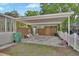 Attached carport offering covered parking with an adjacent fenced yard at 441 N Julia Ave, Deland, FL 32720