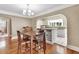 Bright dining room featuring hardwood floors, chandelier lighting, and a decorative buffet cabinet at 441 N Julia Ave, Deland, FL 32720