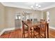 Charming dining room features warm hardwood floors, a wooden dining table, and neutral wall colors at 441 N Julia Ave, Deland, FL 32720