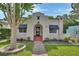 Charming stucco home with a beautiful front yard, walkway, and well-maintained landscaping at 441 N Julia Ave, Deland, FL 32720