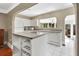 Bright kitchen features a functional island, white cabinets, and modern appliances at 441 N Julia Ave, Deland, FL 32720