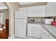 Bright kitchen with white cabinets, granite countertops, stainless steel appliances, and tile flooring at 441 N Julia Ave, Deland, FL 32720