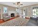 Cozy living room features hardwood floors, a fireplace, and access to the patio at 441 N Julia Ave, Deland, FL 32720