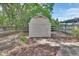 A backyard storage shed with double doors and a pathway to additional outdoor space at 441 N Julia Ave, Deland, FL 32720