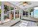 Enclosed sunroom with lots of natural light and a peaceful view of the outdoor patio and backyard at 441 N Julia Ave, Deland, FL 32720
