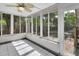 Relaxing sunroom with tile flooring, ceiling fan, and sliding windows overlooking the backyard and patio area at 441 N Julia Ave, Deland, FL 32720