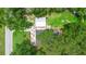 Aerial view of a property with a detached garage, backyard fire pit, and mature trees at 507 Sand Ave, Apopka, FL 32703