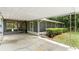View of the back of the home, with screened in lanai and covered parking at 507 Sand Ave, Apopka, FL 32703