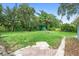 This spacious backyard features lush greenery, a storage shed, and a brick patio for outdoor enjoyment at 507 Sand Ave, Apopka, FL 32703