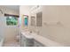 Bright bathroom featuring a vanity, mirror, tile floors, and shower/tub at 507 Sand Ave, Apopka, FL 32703