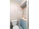 Small bathroom with blue vanity, toilet and shower at 507 Sand Ave, Apopka, FL 32703
