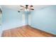 Light-filled bedroom with wood-look floors, ceiling fan, and closet space at 507 Sand Ave, Apopka, FL 32703