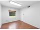 Small bedroom with vinyl floors, window and blank walls at 507 Sand Ave, Apopka, FL 32703