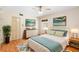 Bright, airy bedroom features warm hardwood floors and stylish decor at 507 Sand Ave, Apopka, FL 32703