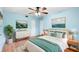 Serene bedroom with tranquil blue walls, a ceiling fan, and neutral decor at 507 Sand Ave, Apopka, FL 32703