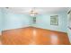 Spacious bedroom with wood floors, ceiling fan and two windows with wooded views at 507 Sand Ave, Apopka, FL 32703