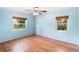 Bright bedroom with wood-look floors and two windows at 507 Sand Ave, Apopka, FL 32703