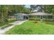 Charming home with a well-maintained lawn, covered parking, and a screened porch at 507 Sand Ave, Apopka, FL 32703