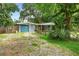 Exterior of a home featuring a well-kept lawn, covered parking, and charming curb appeal at 507 Sand Ave, Apopka, FL 32703