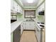 Functional kitchen featuring white cabinetry, stainless sink, and essential appliances at 507 Sand Ave, Apopka, FL 32703