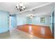 Bright, open-concept living room featuring hardwood floors, ceiling fan, and ample natural light at 507 Sand Ave, Apopka, FL 32703